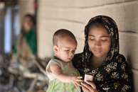 Mother with mobile phone in Bangladesh