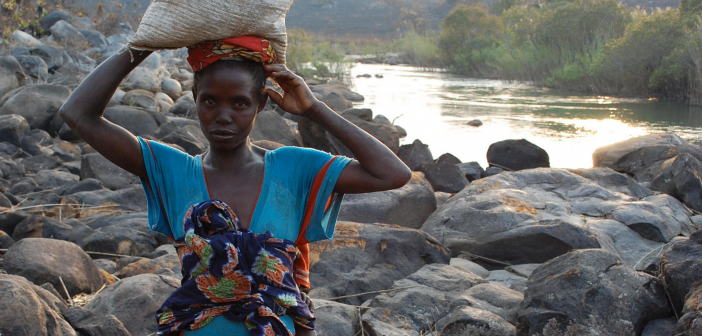 Angola A woman in Angola carries water gathered from the river for washing clothes and bathing her child. Access to clean water is a luxury in rural Angola and many people, like this woman, walk more than 8 kilometres, with their clothing and food on their heads and their babies on their backs.
© 2009 Stephanie VandenBerg, Courtesy of Photoshare