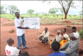 A community change agent (CCA) shows community members in Tanzania a flipchart about malaria. CCAs work through the USAID-funded COMMIT project. © 2014 JHUCCP/USAID COMMIT Project, Courtesy of Photoshare